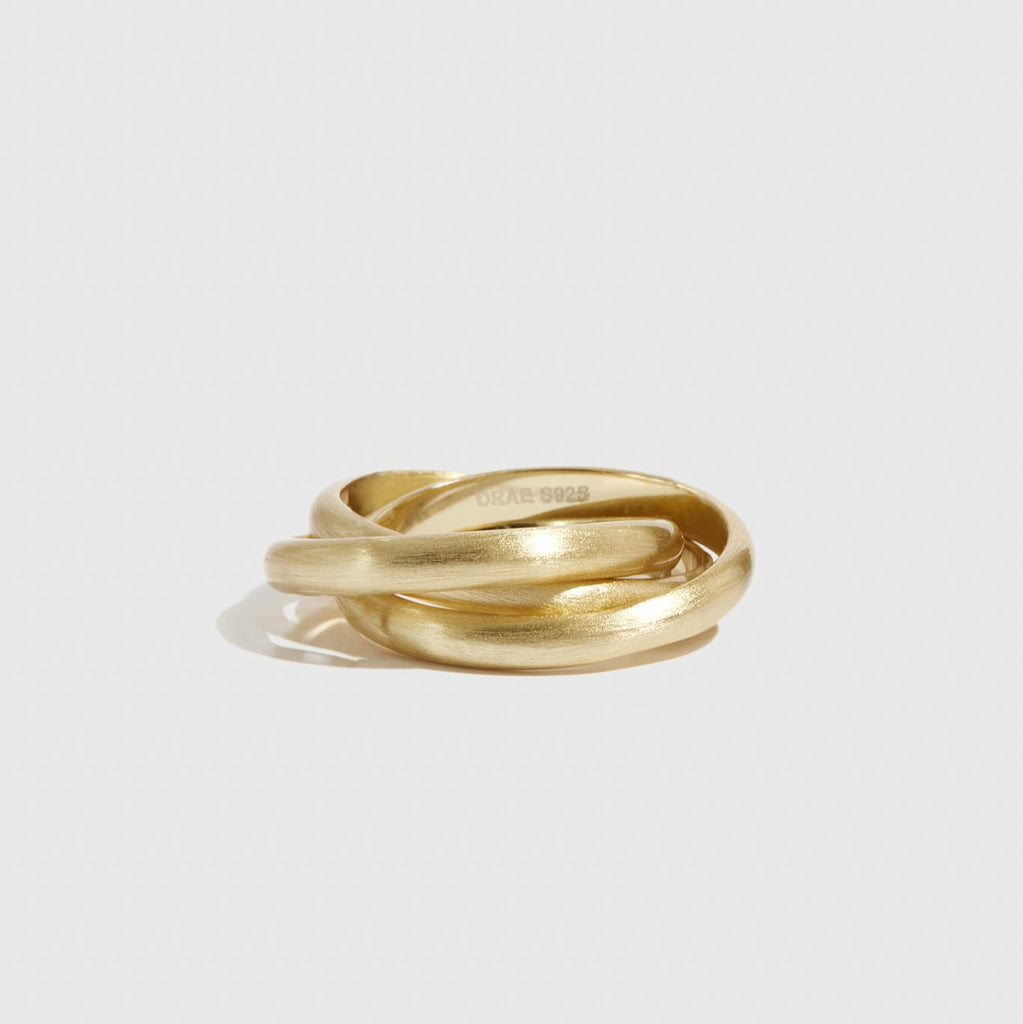 Gold ring on a light gray background