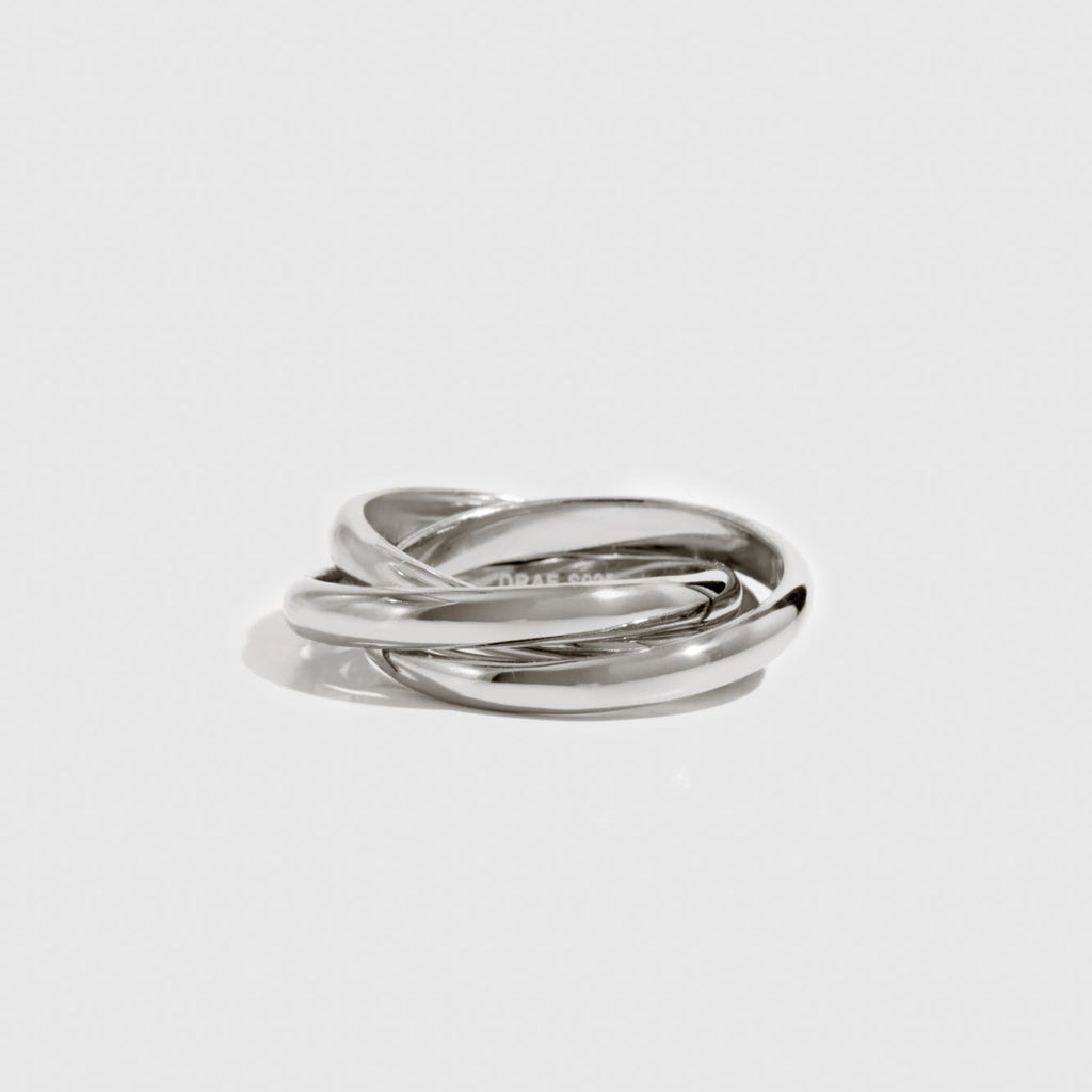 Silver ring on a light gray background